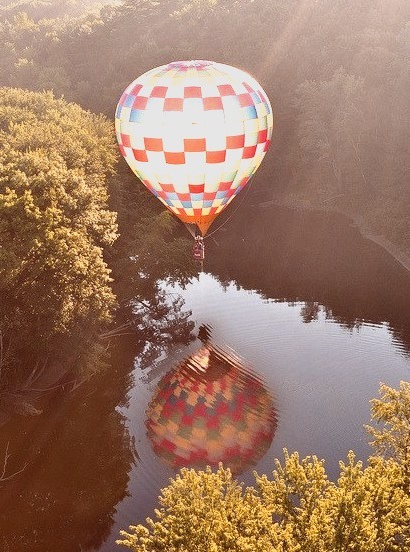 Hot-air balloon reflected in a river near Hillsborough, New Hampshire, USA